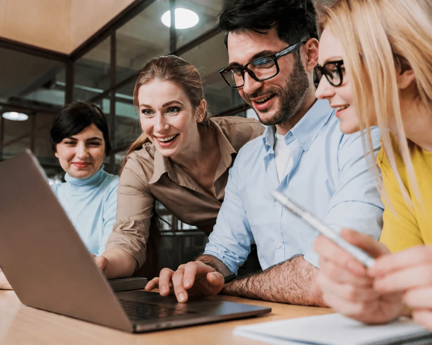 People working together on laptops at a table.