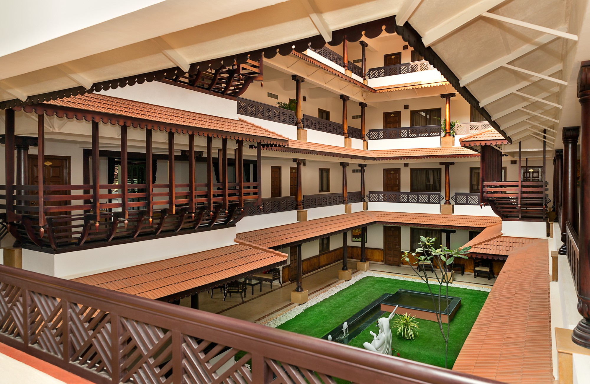 Aerial view of a winding road cutting through rocky terrain and sandy landscape.