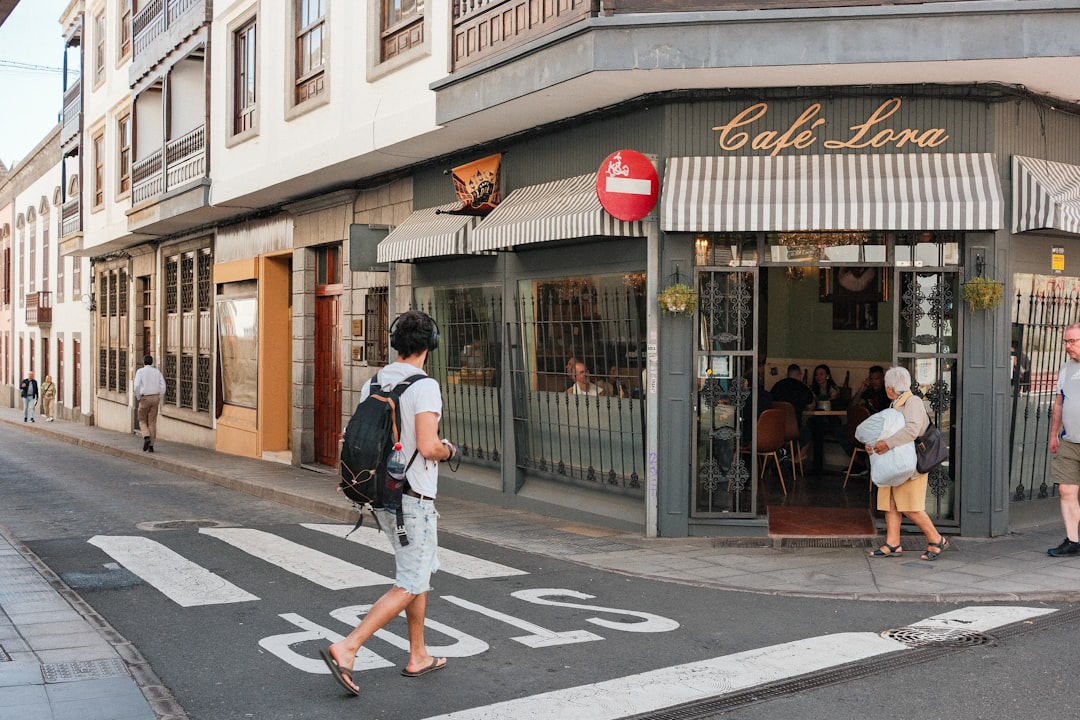 A group of people walking across a street