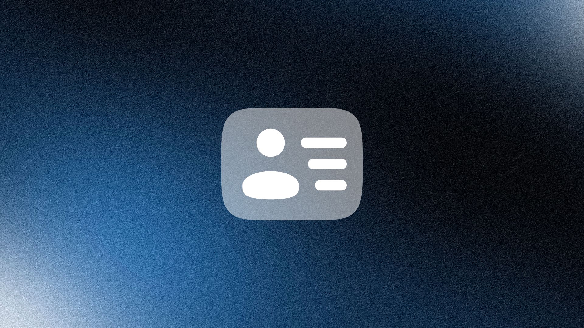 Smiling woman wearing a beige blazer and grey shirt, holding a folder while standing by a sunlit wall.