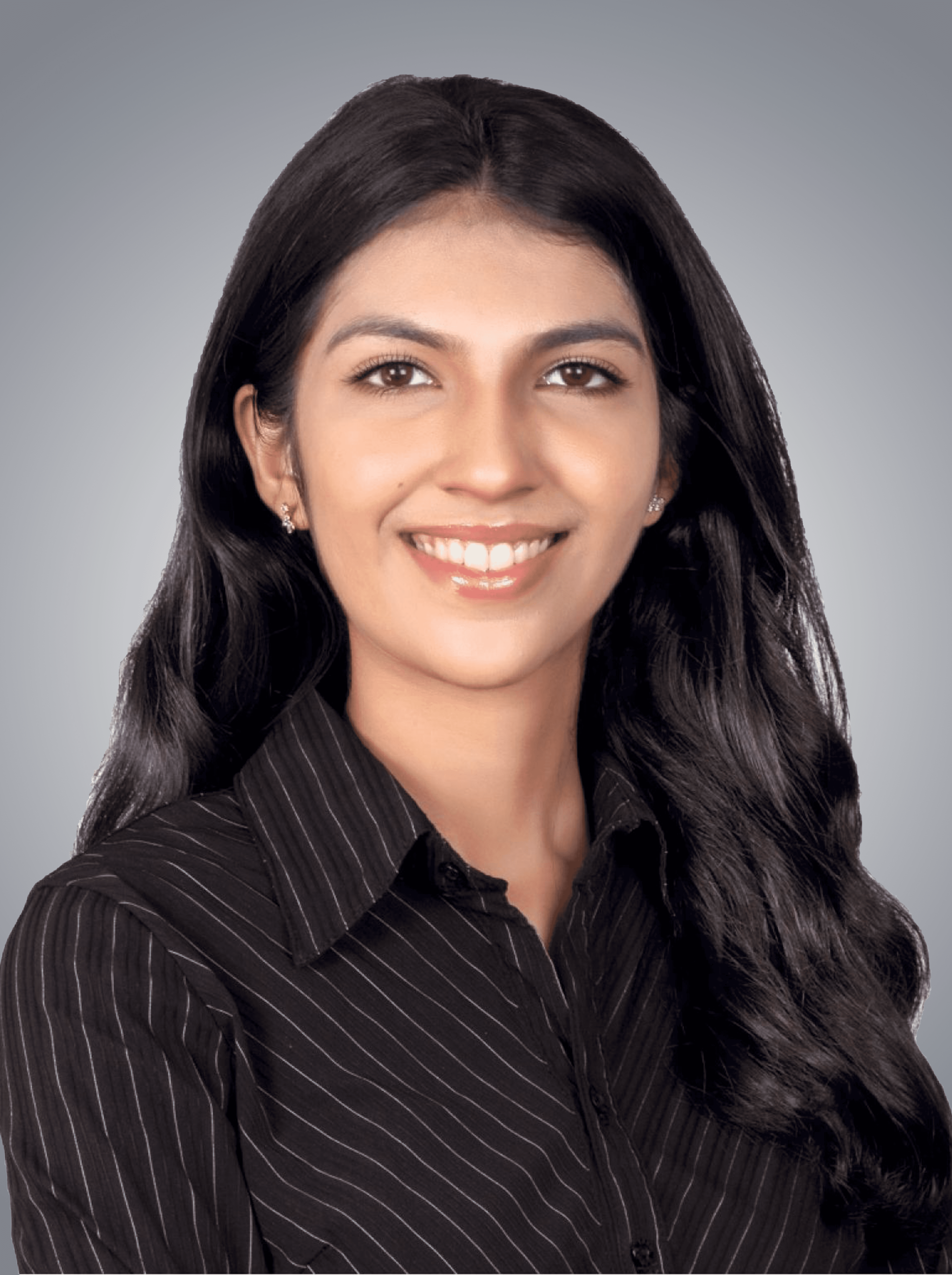 A woman with short curly hair wearing a black t-shirt looks into the camera.