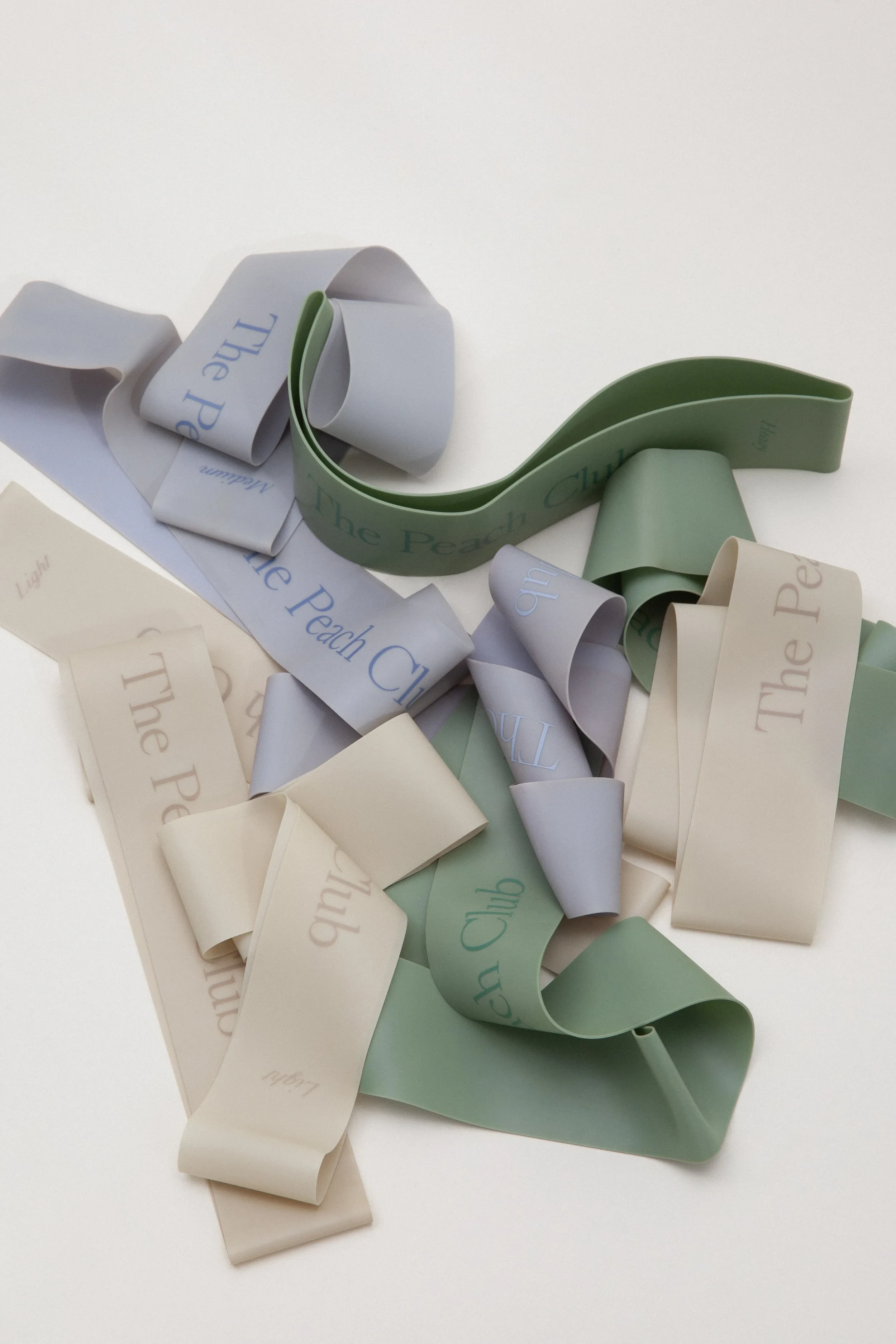 The Peach Club visual identity applied to resistance bands.