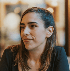 Sara is a client smiling to the camera happily