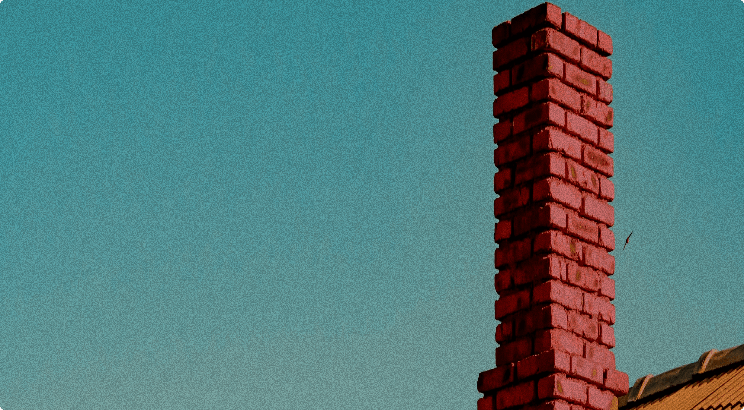 Vibrant brick chimney with the sky in the background.