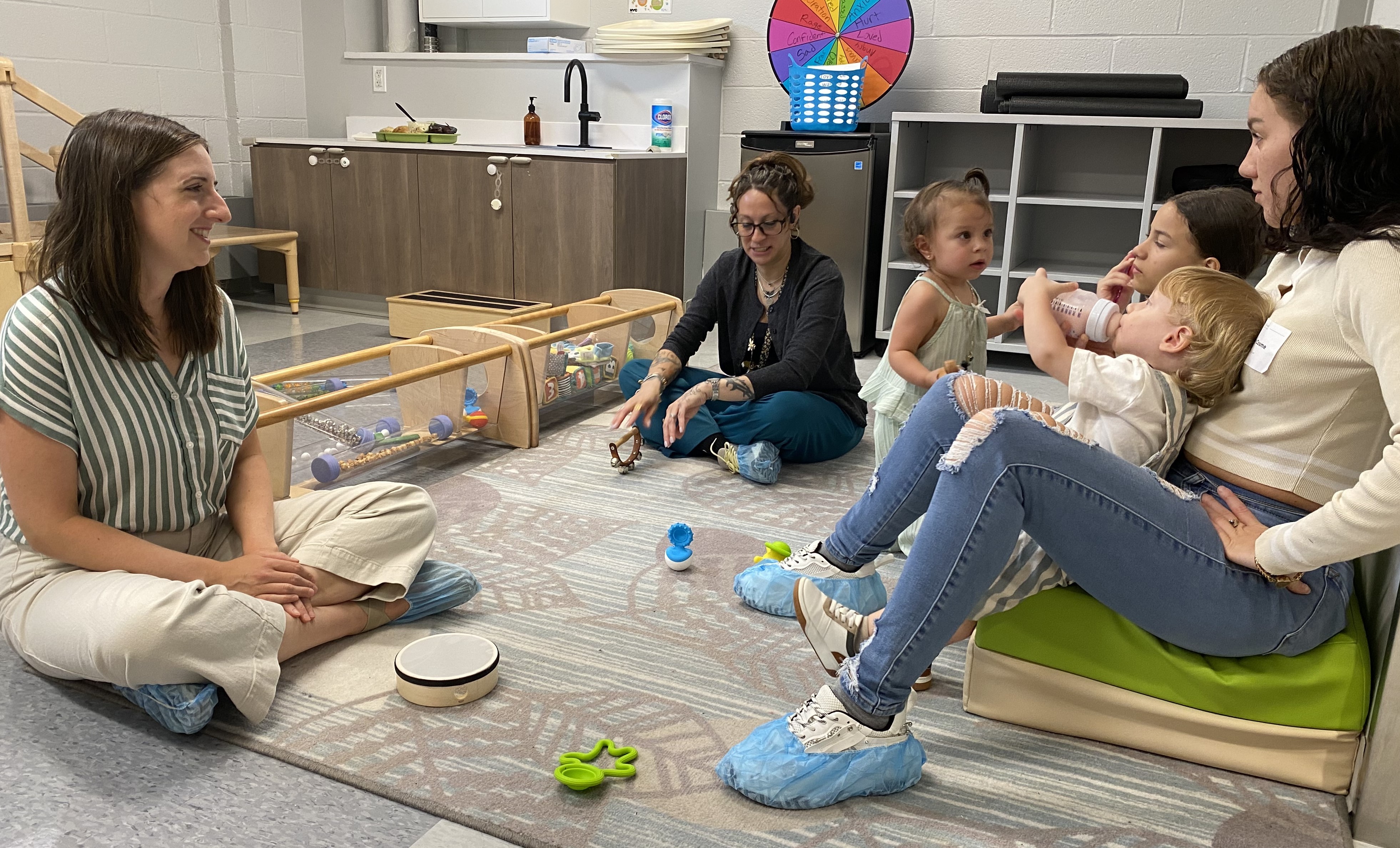 Staff and moms play with their babies and toddlers.
