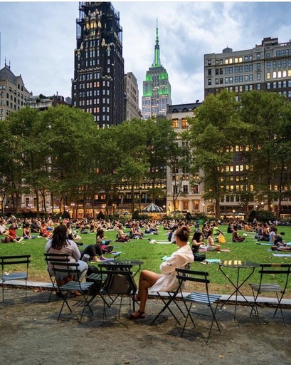 A view of a city skyline with a body of water in the foreground