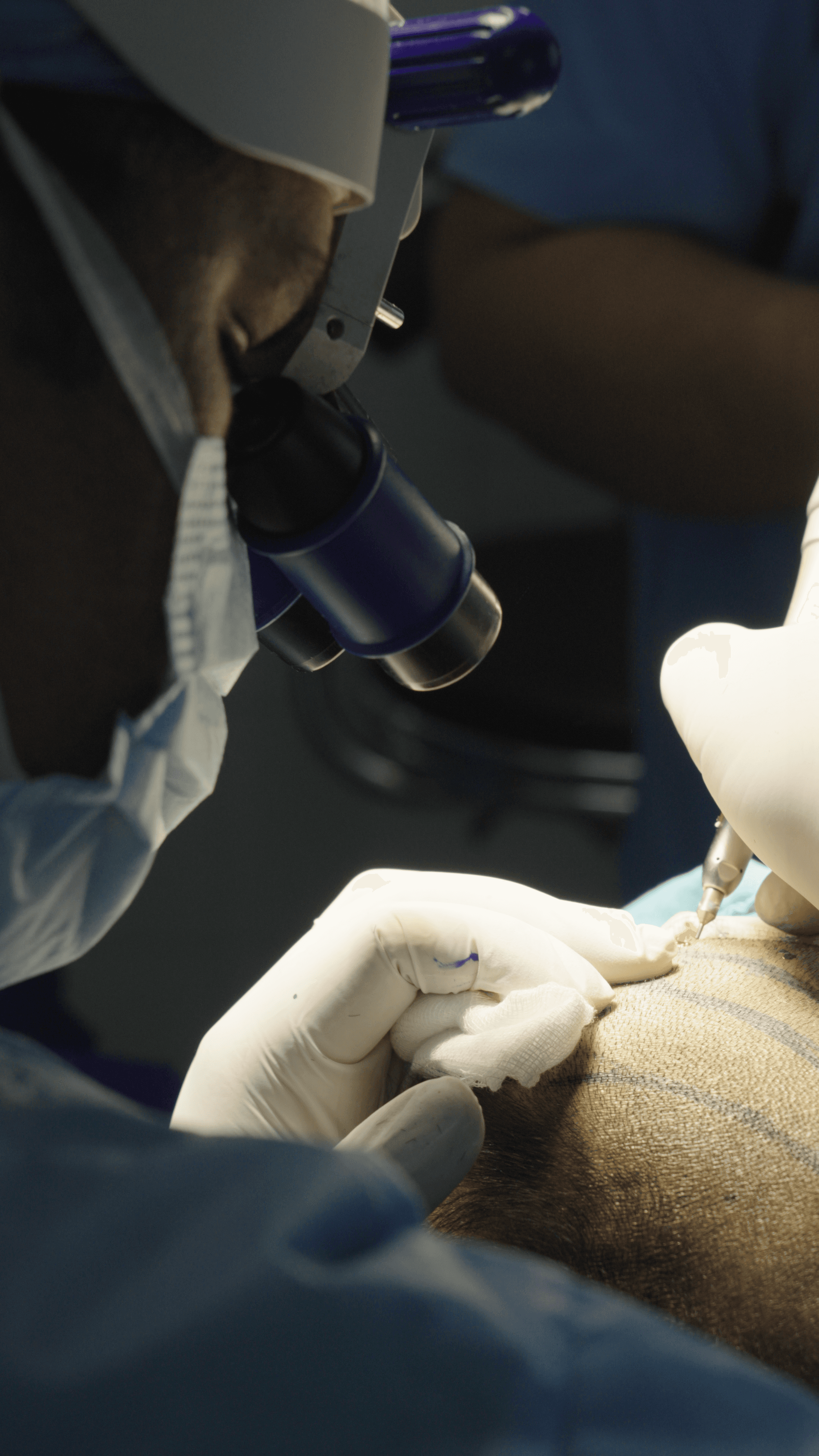 Dental professional in black gloves performing procedure with drill and mirror on patient in clinic
