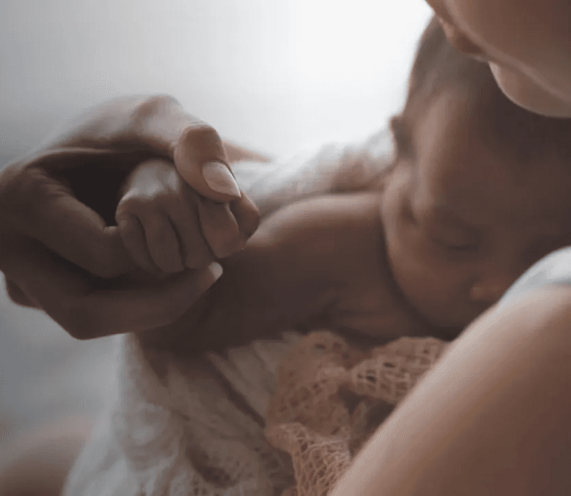 Woman with her new born baby in her arms representing Flouria’s Postpartum care