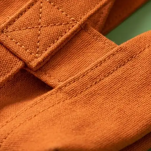A close up shot of a orange colour tore bag handle and its workmanship