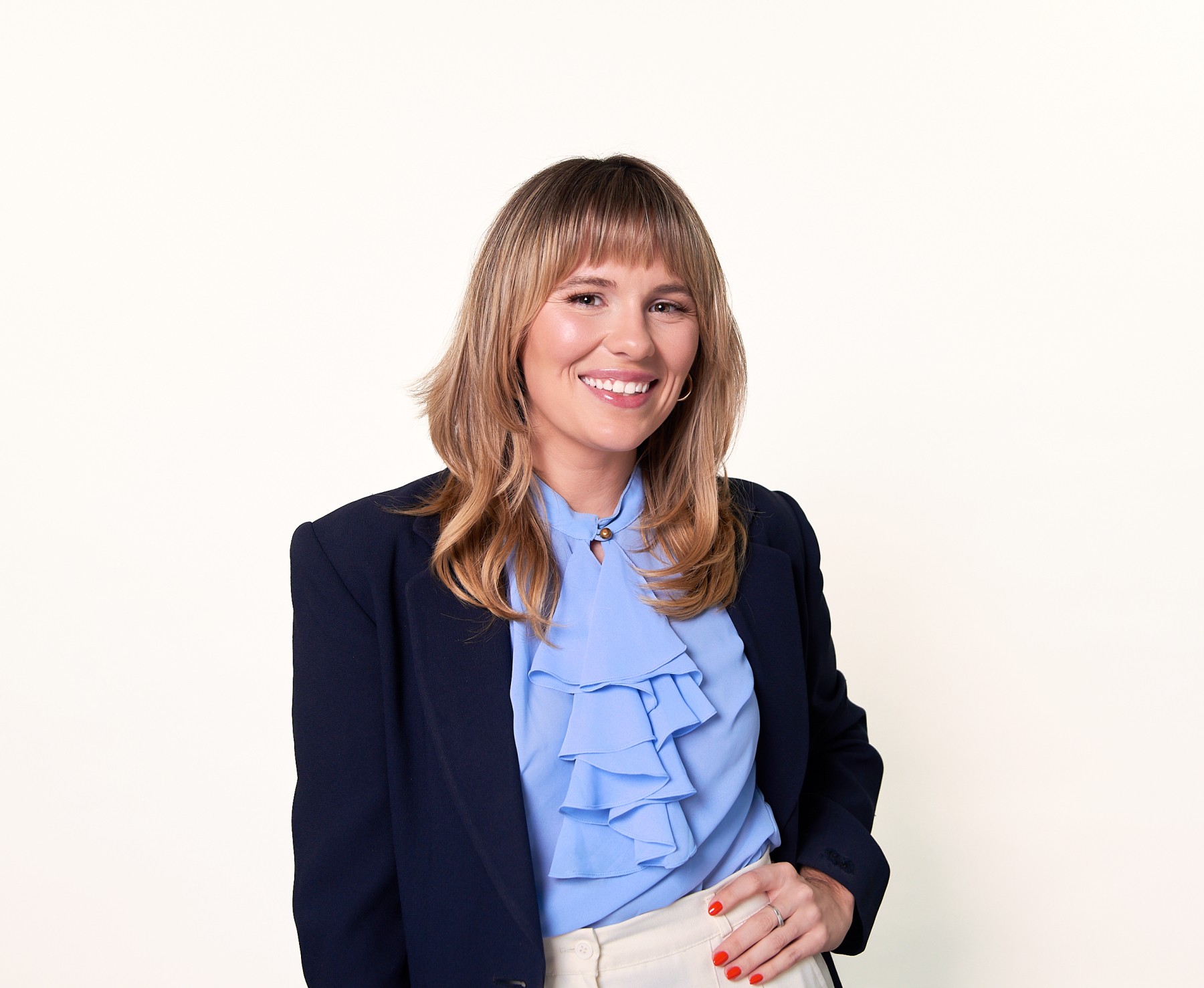 female attorney in blue business outfilt photographed on a white backdrop