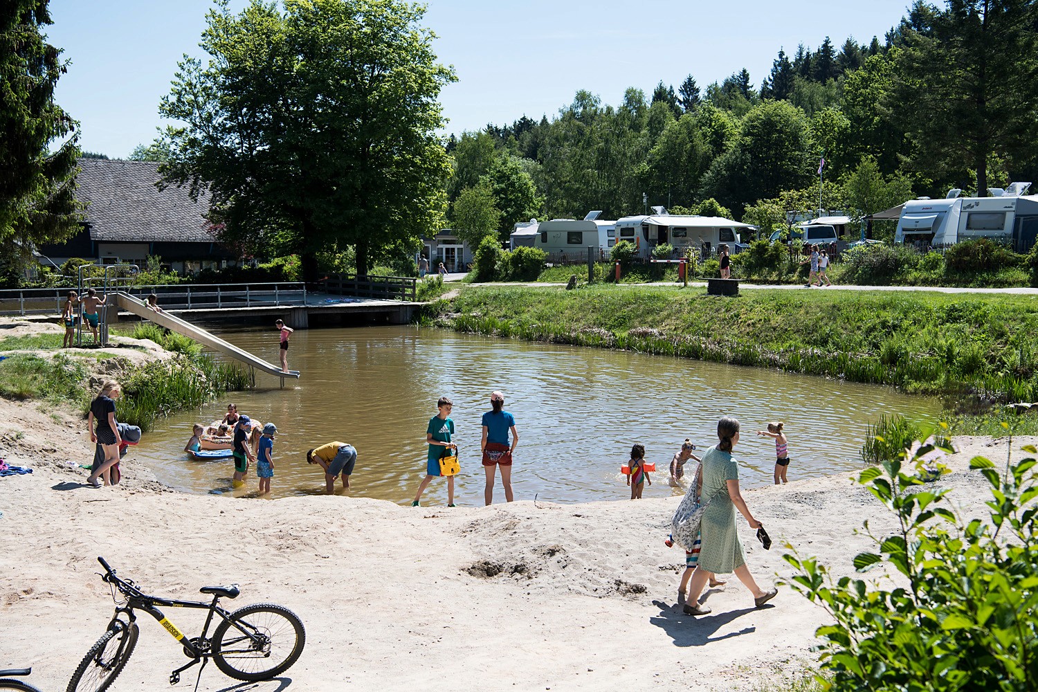 Swimming lake with caravan in the background