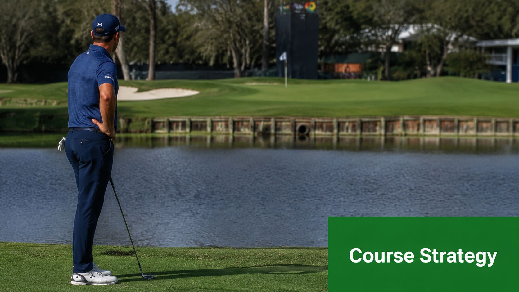 A professional golfer standing on the course green, contemplating his next shot across the water hazard.