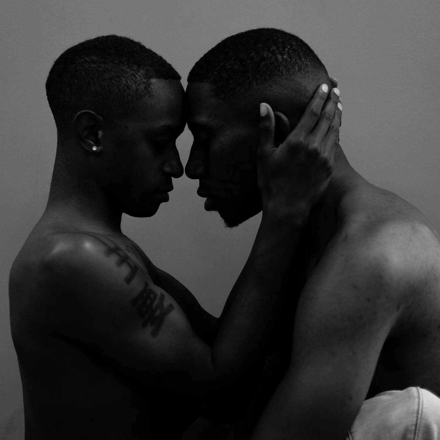 Intimate moment between two men embracing, symbolizing connection, vulnerability, and healing through gay-affirming therapy in Los Angeles.