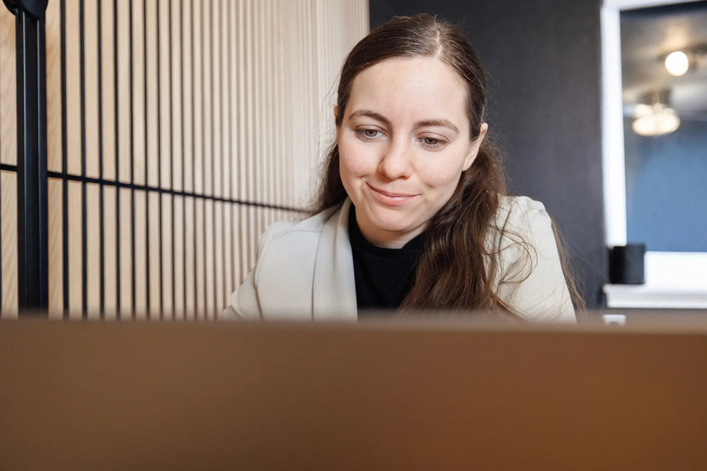 Photo of designers looking at a MacBook screen