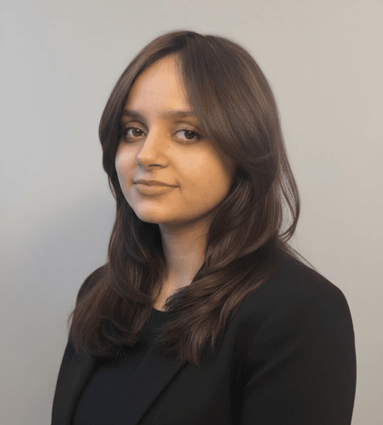 woman leans on gray concrete wall