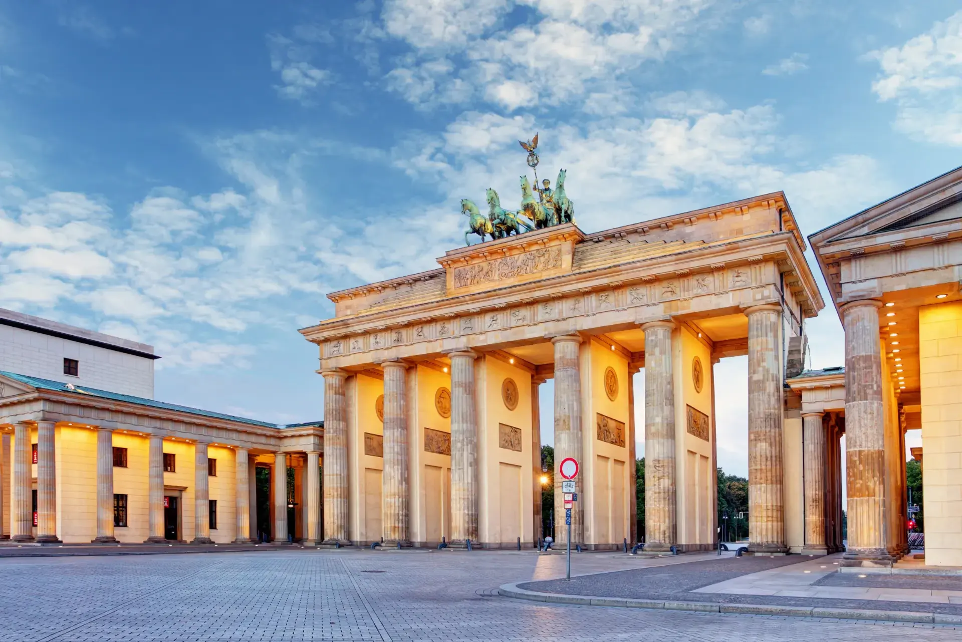 Das ikonische Brandenburger Tor in Berlin, erleuchtet unter einem strahlend blauen Himmel.
