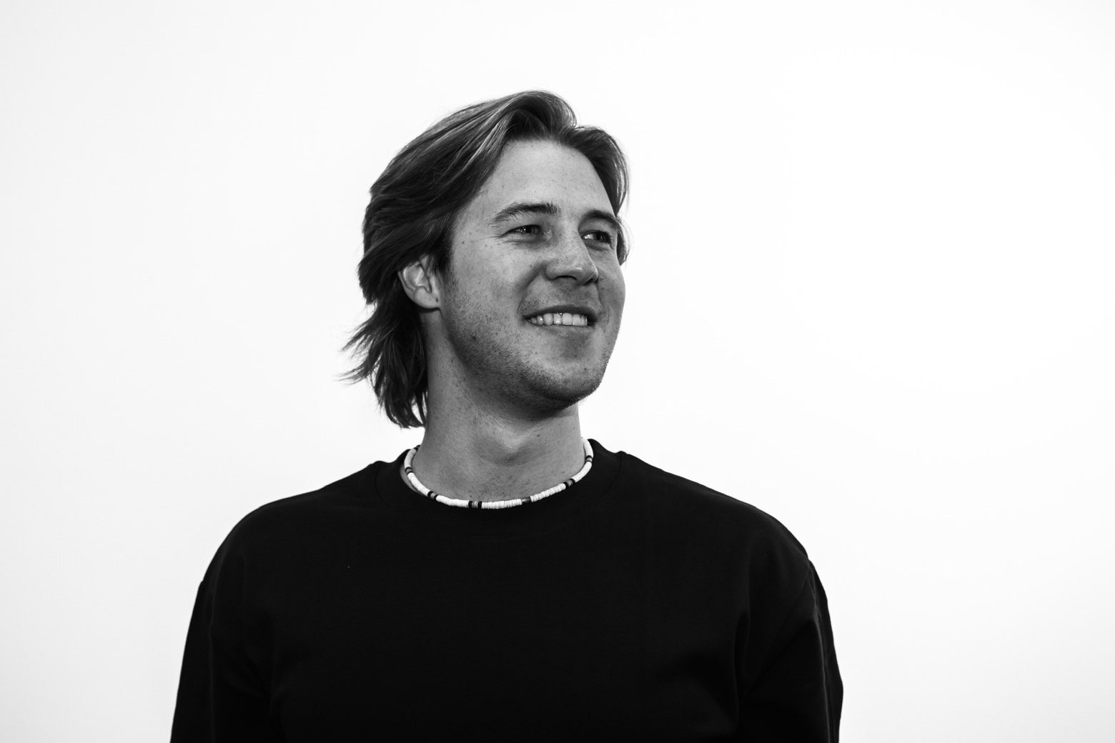 man in gray polo shirt smiling