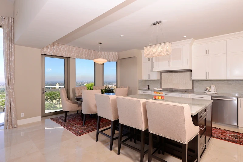 Harbor Ridge Transitional Remodel featuring a sleek kitchen with bar seating and scenic views.