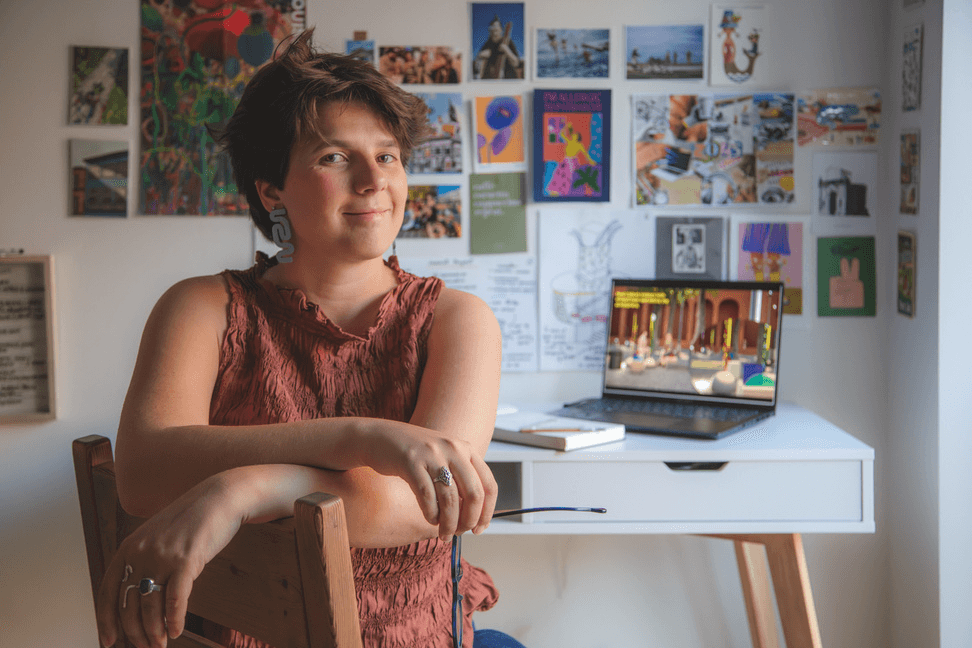 A thoughtful young person with dark hair gazes to the side, captured in soft black and white lighting.