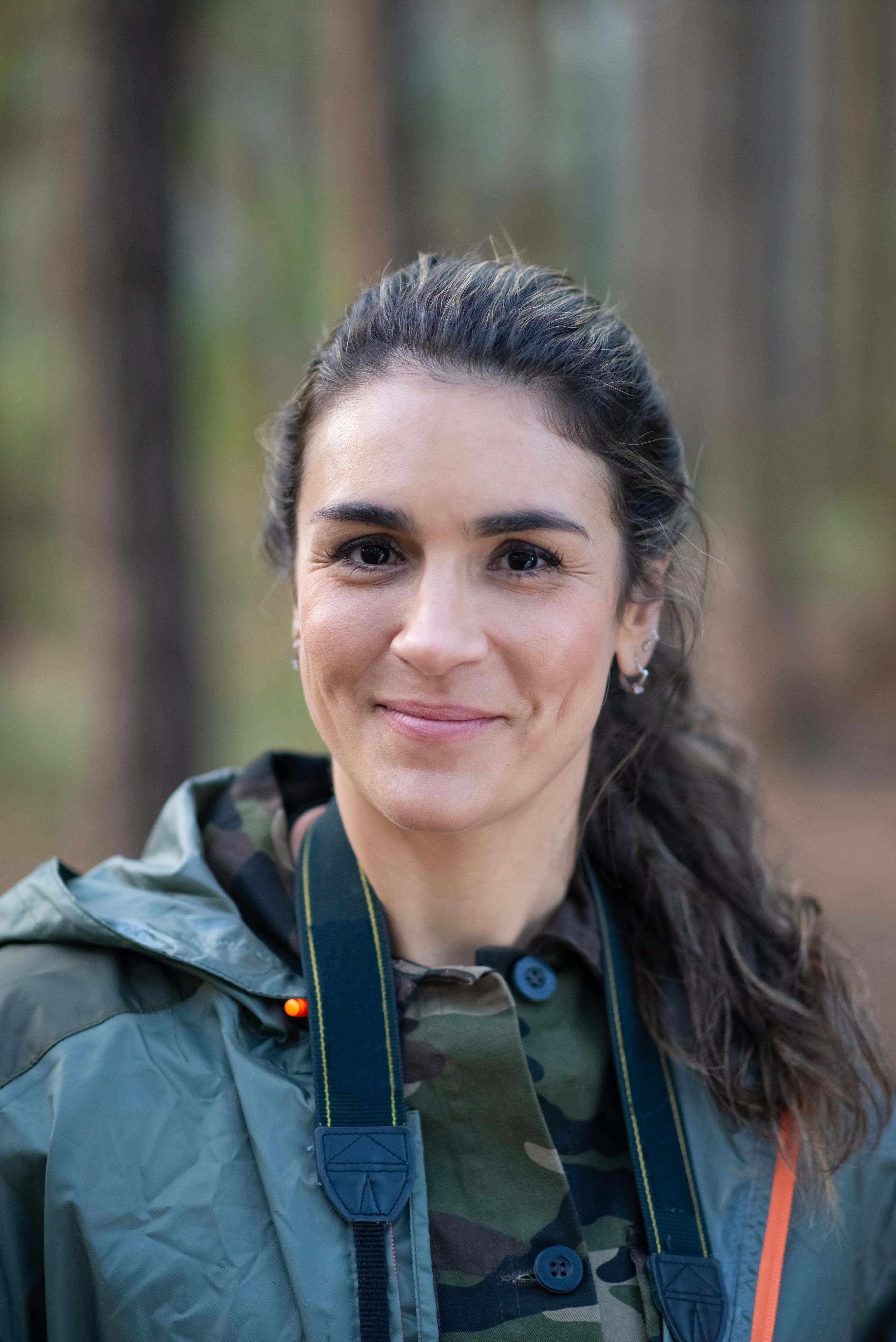 Professional portrait of a young woman with black hair outdoors