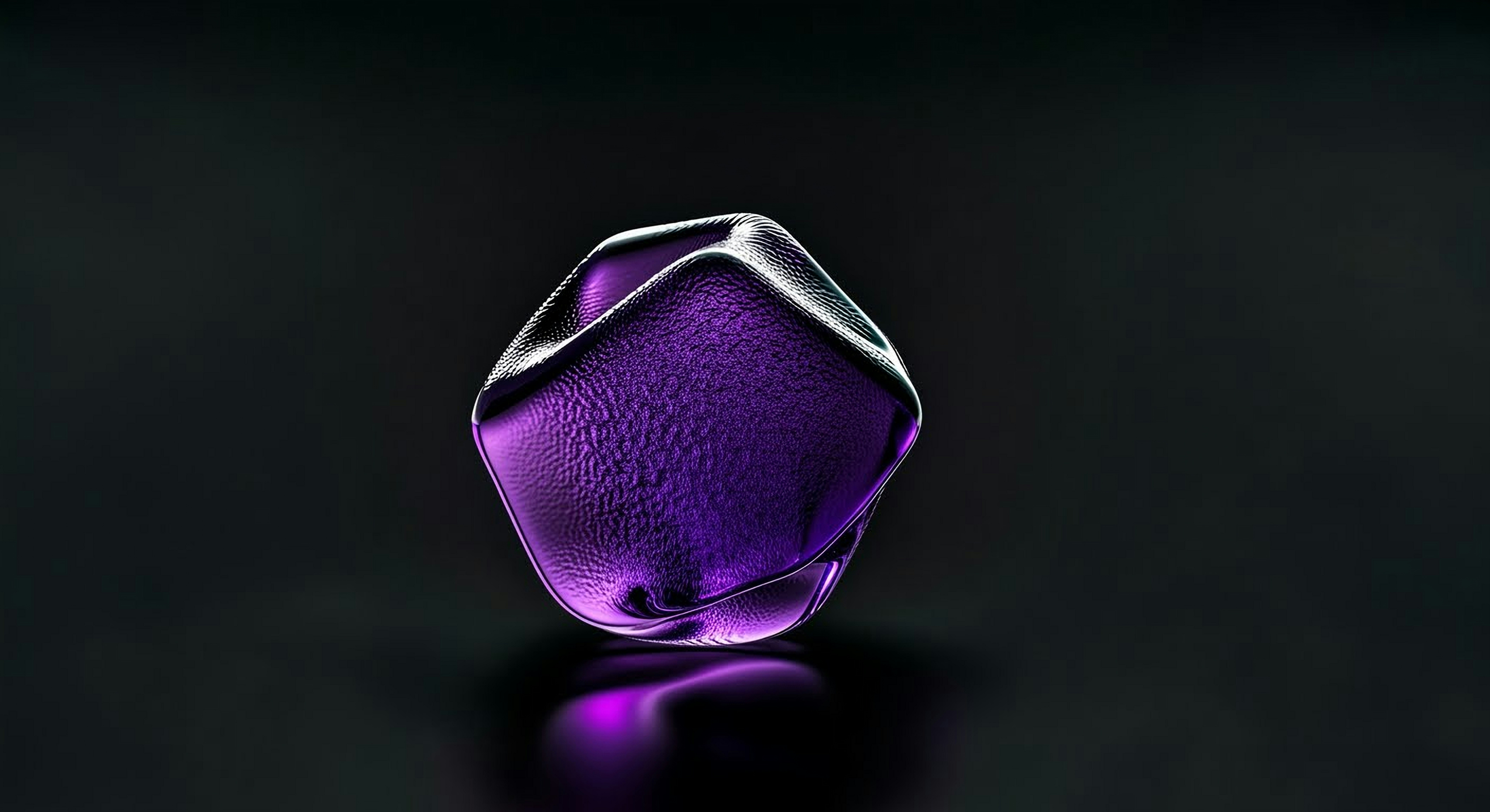 A translucent purple gem on a dark reflective surface.
