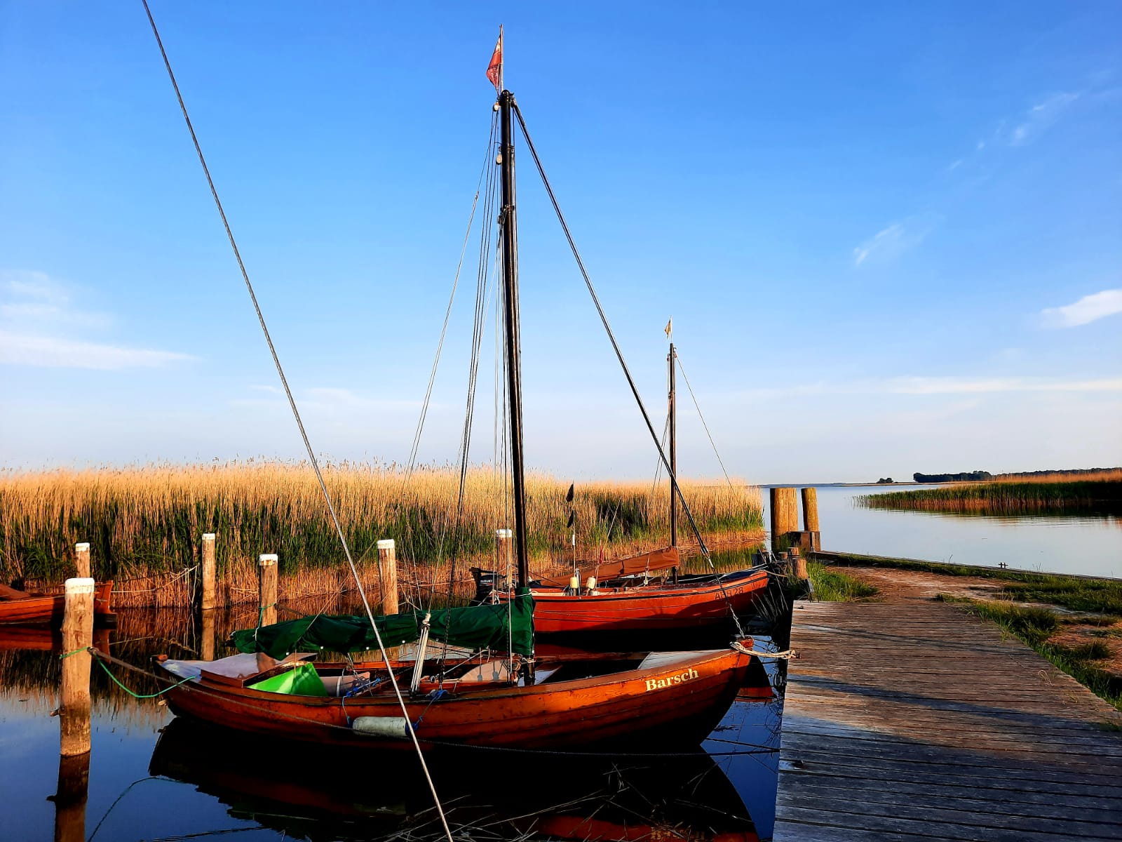 A quiet coastal home beside water and pale shoreline