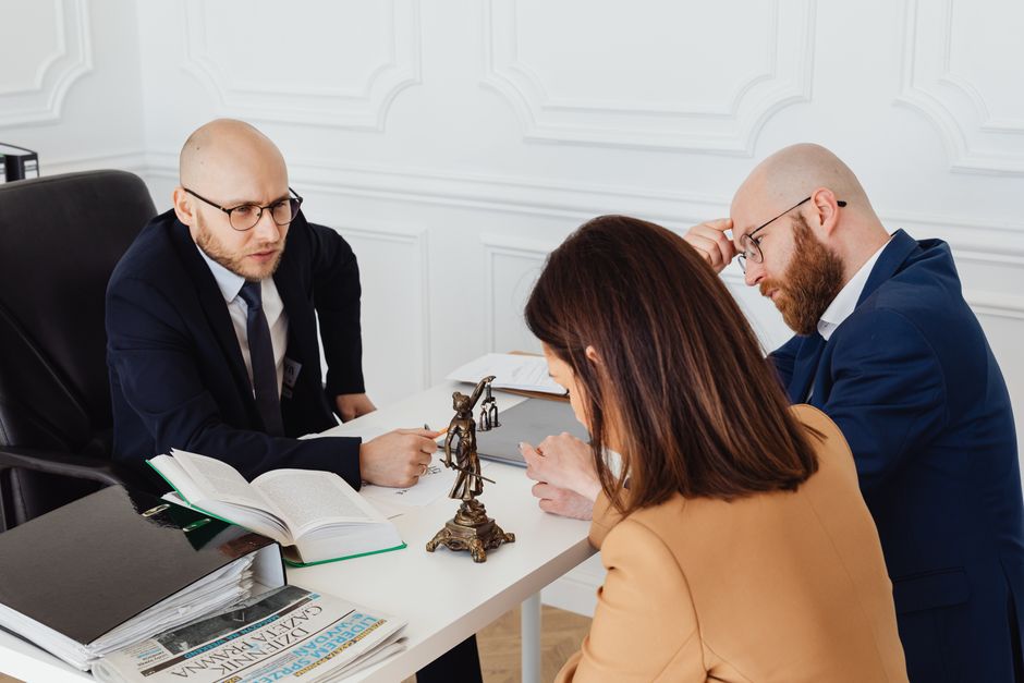 An attorney consulting with a client in a professional office setting