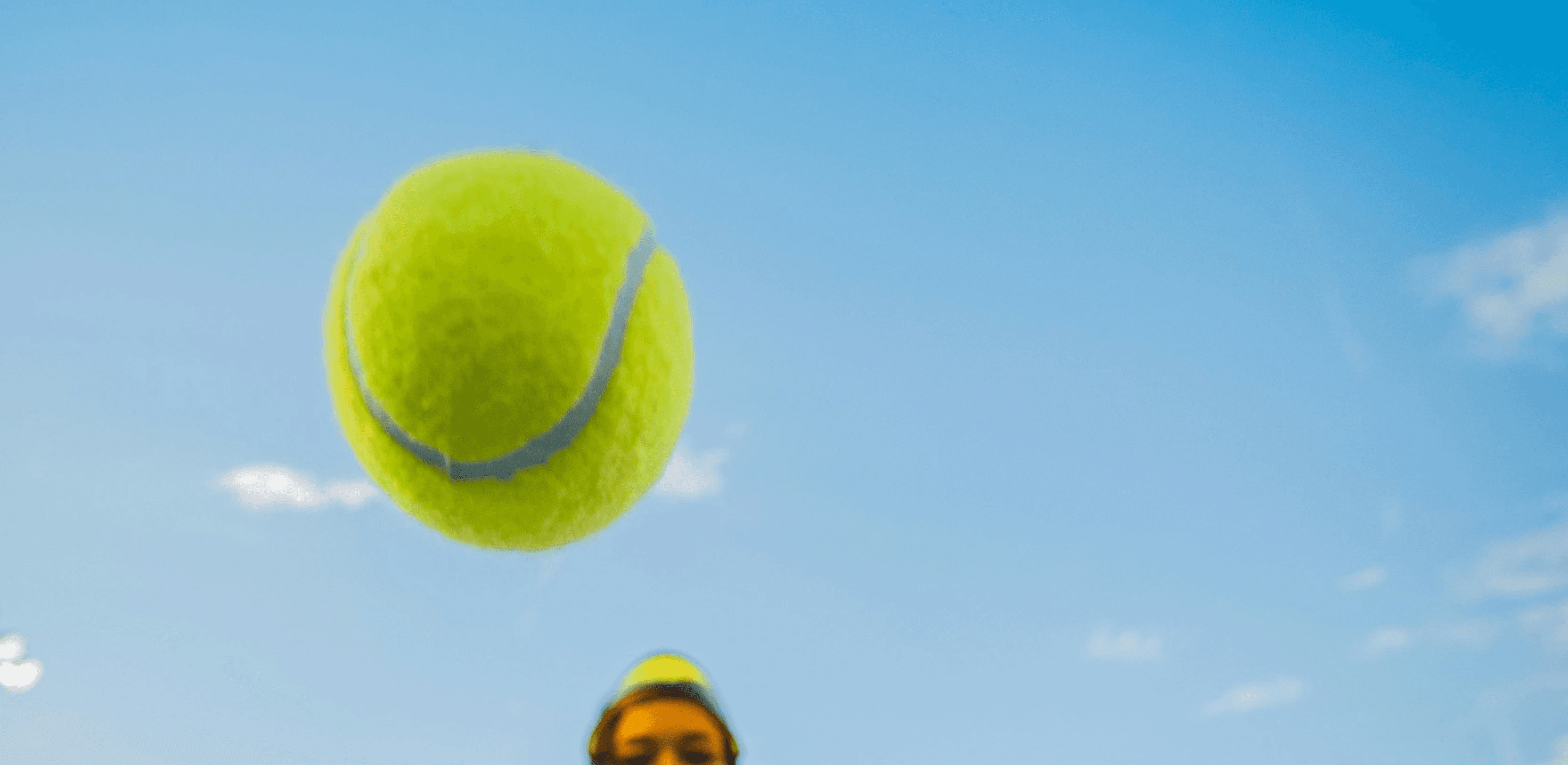 woman in black jacket and black pants holding tennis racket under blue sky during daytime