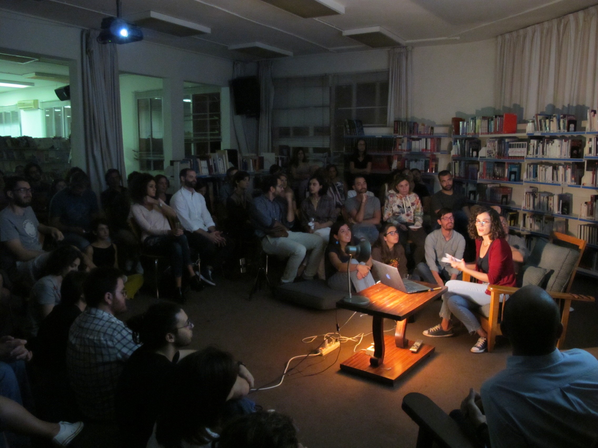 three people sitting in front of table laughing together