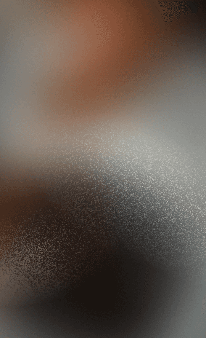 A woman named Jenny O with black hair smiles while sitting on a wooden surface, with shelves in the background.