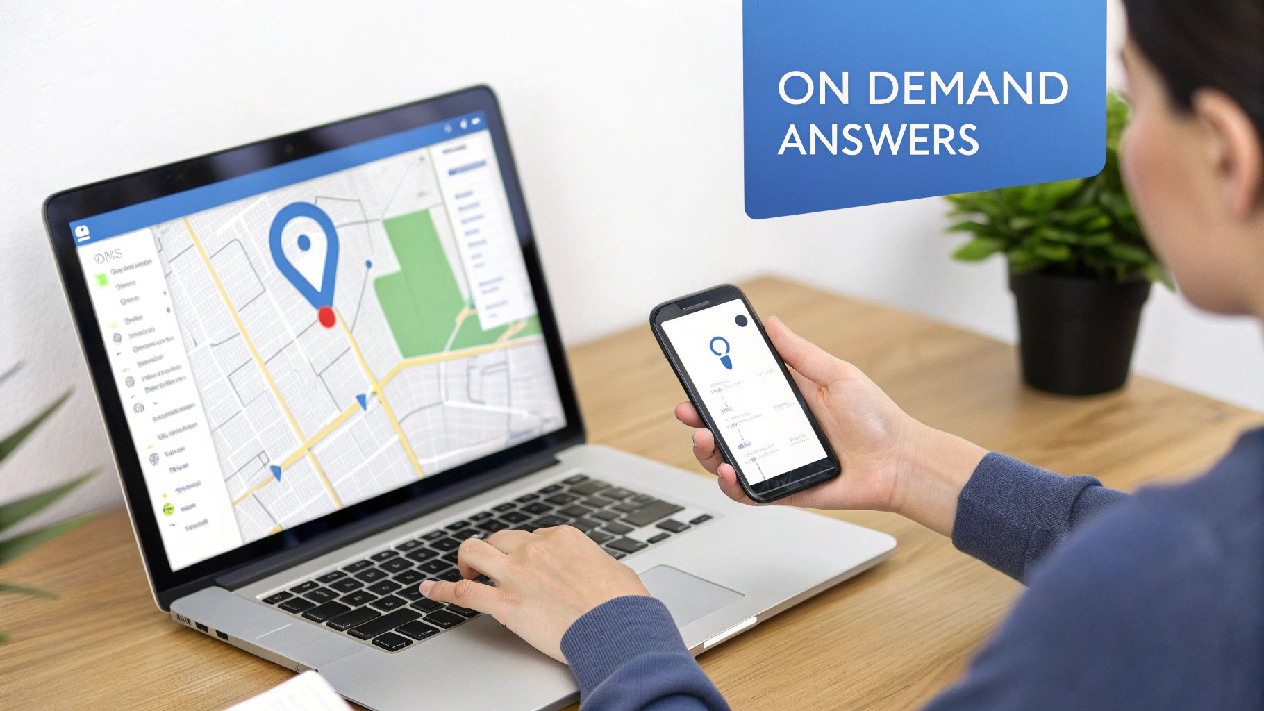 Person using a laptop and smartphone with map and location tracking applications for business insights.