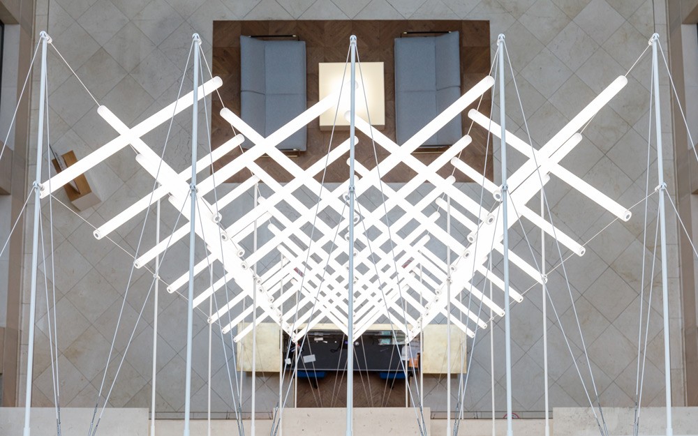 View from above the installation highlighting geometric zig-zag pattern of suspended acrylic LED units