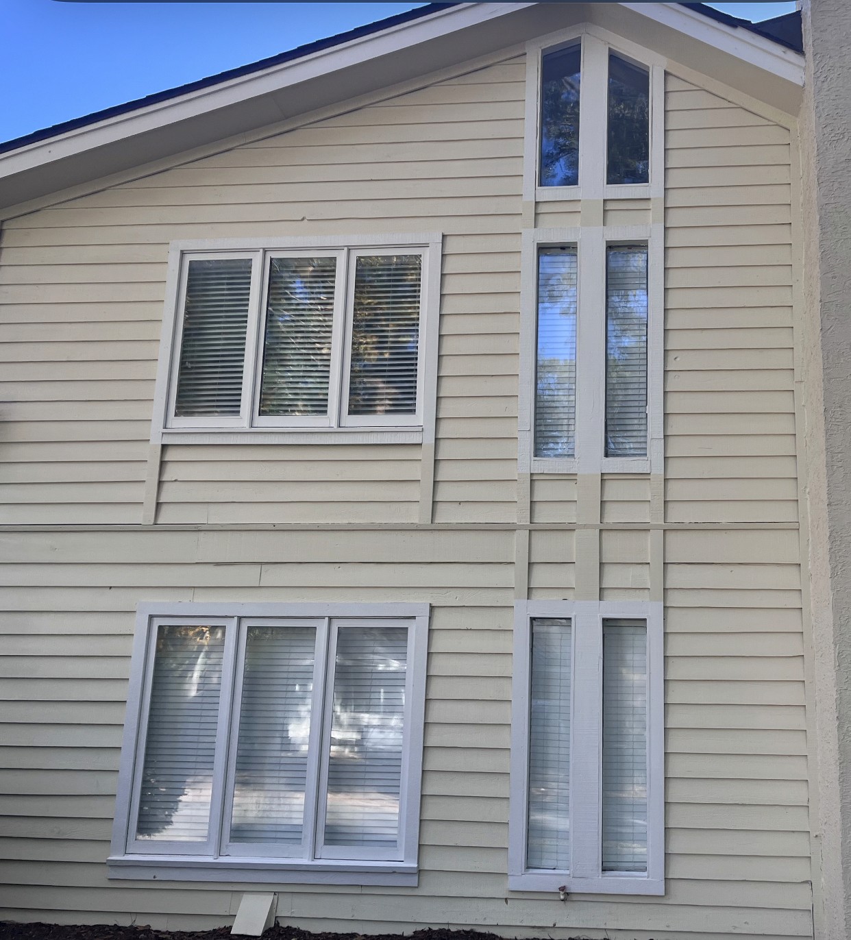Before and after—home siding soft washed, surface free from algae and grime