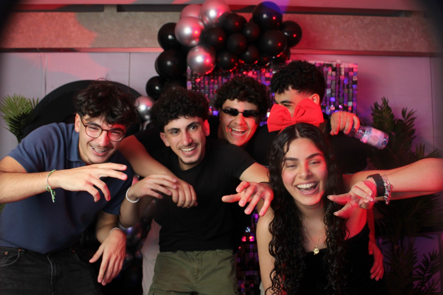 happy group of friends at a party posing for the picture.