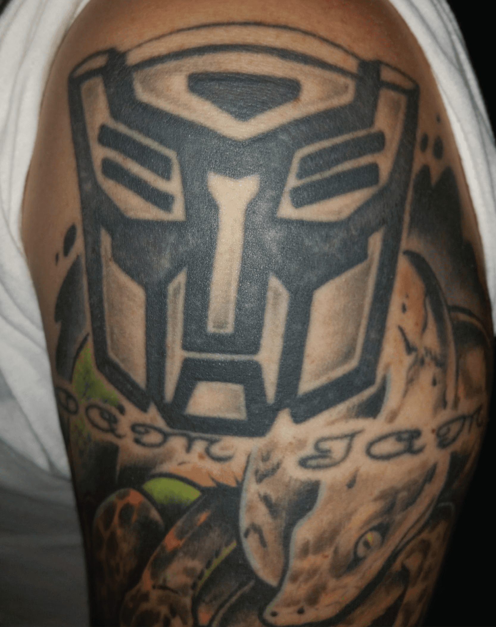 Before image of dense black shoulder tattoo