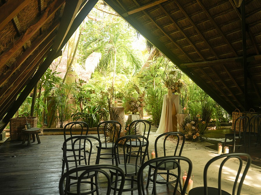 Group of people discussing their spiritual yoga journey on the beach at Nomade Holbox in Tulum Mexico, with a serene and peaceful atmosphere