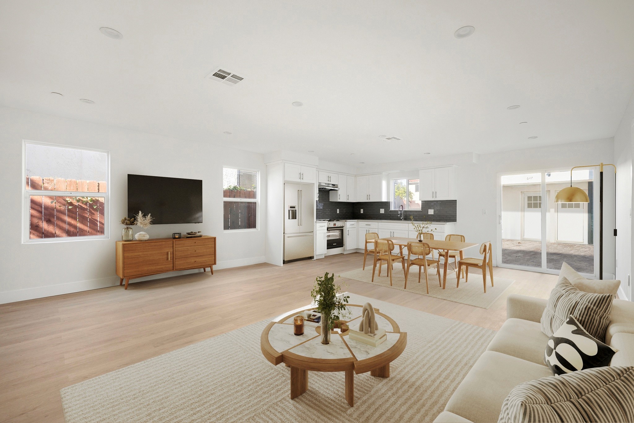 Bright open-concept living room with modern finishes and wide plank flooring at 645 west 97th street.
