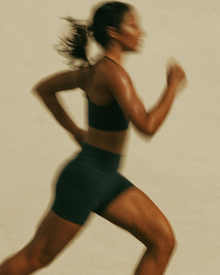 a group of women standing on top of a sandy beach