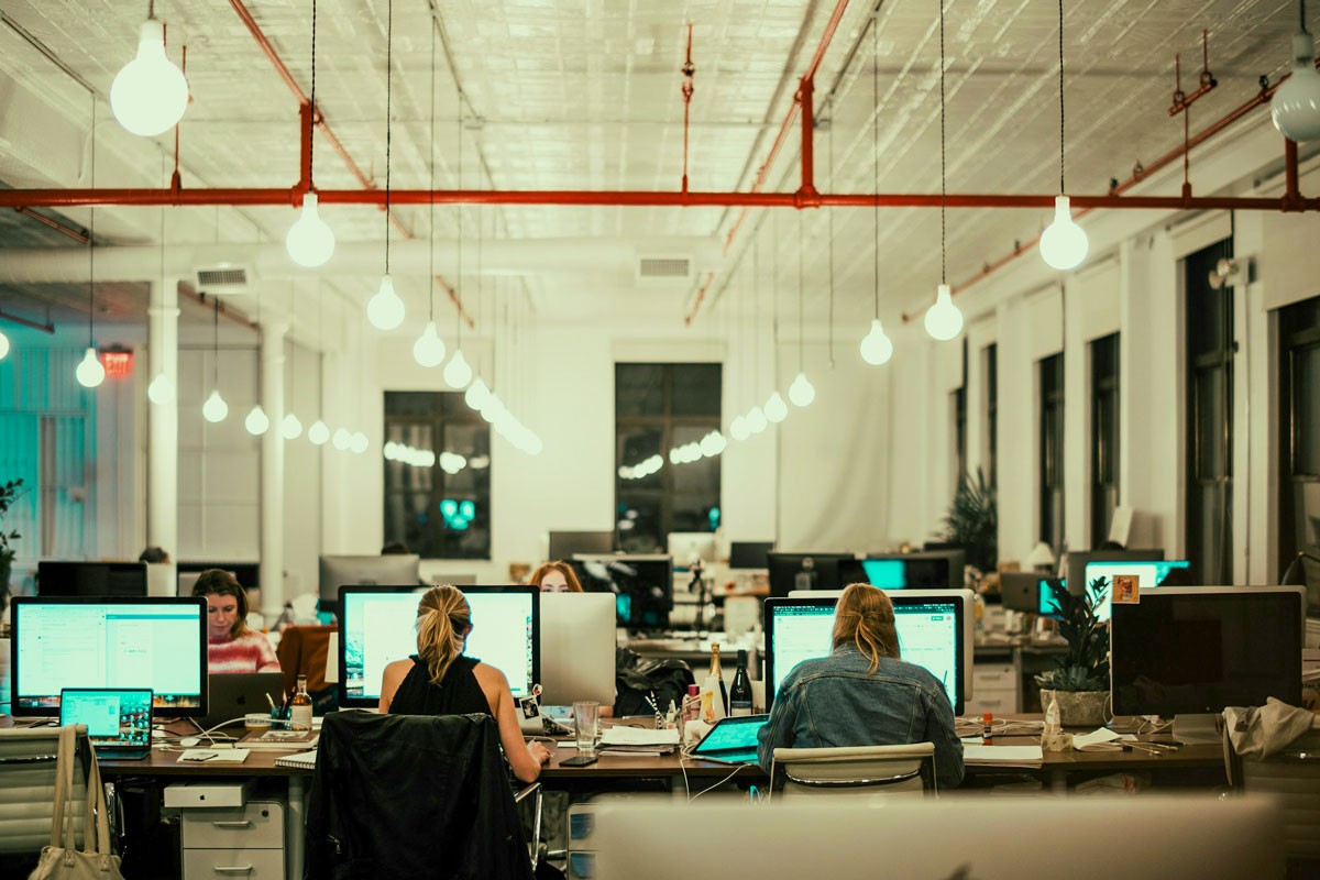 Large open space office with people on their computers.