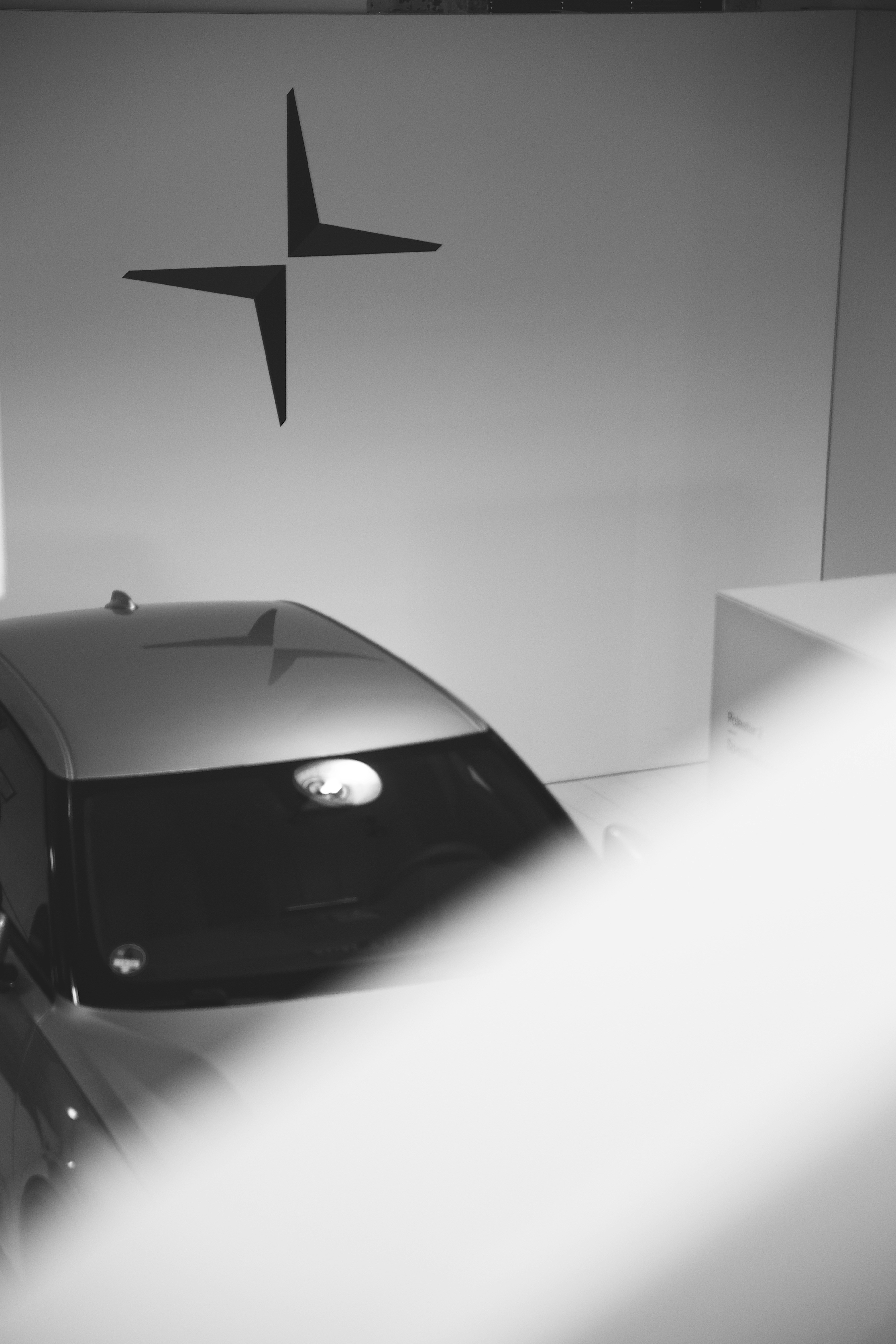 a-black-and-white-photo-of-a-car-in-a-showroom - sebastian-wagner (unsplash)./pho