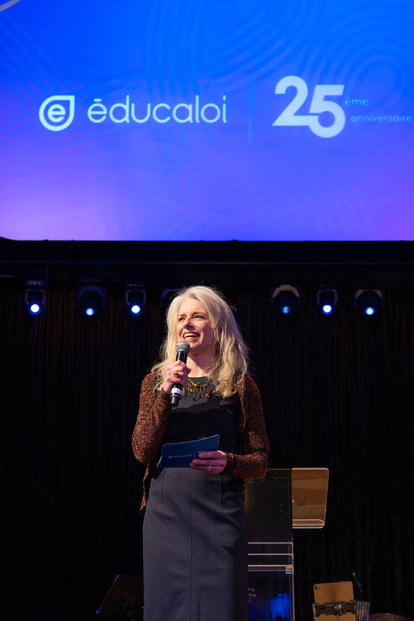 Corporate event photography of a woman giving a speech during the Éducaloi anniversary celebration in Montreal