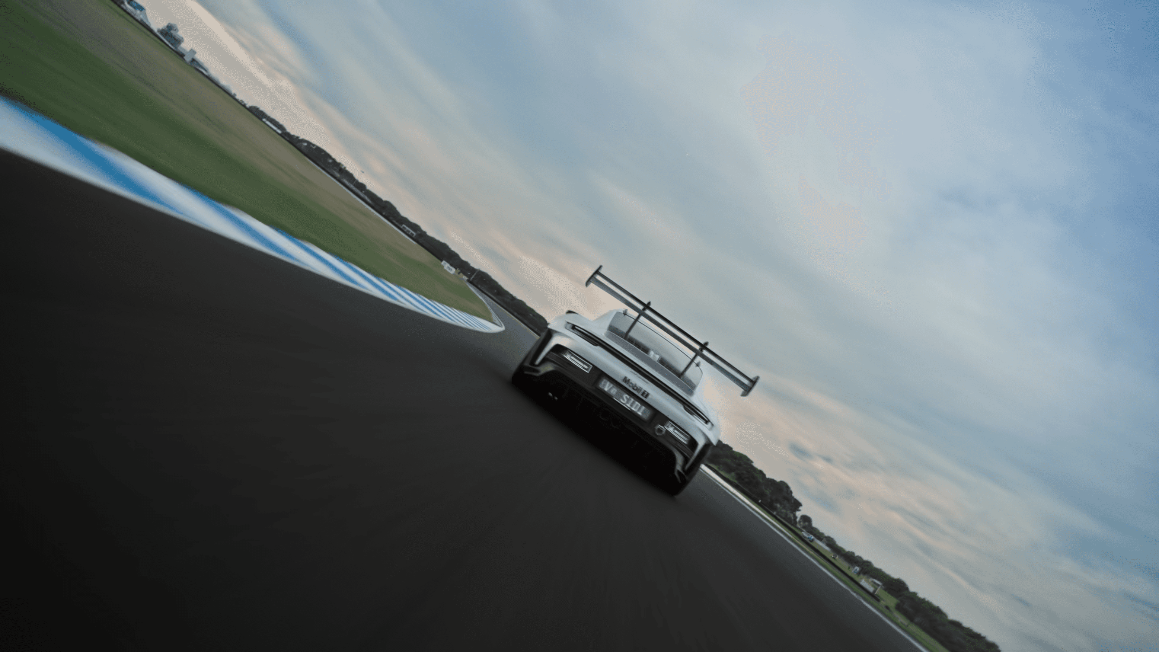A model standing in front of tall city skyscrapers, basking in sunlight, with her head tilted upward