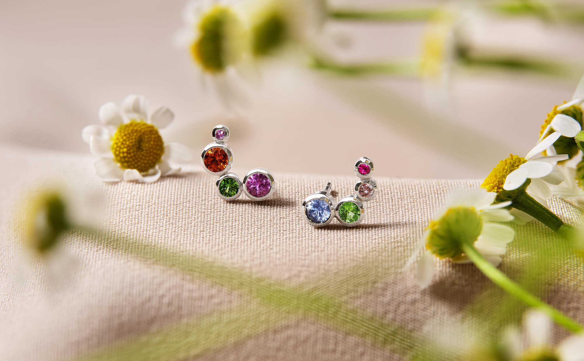 earring and flowers on a soft-colored background, creating a whimsical nature scene.