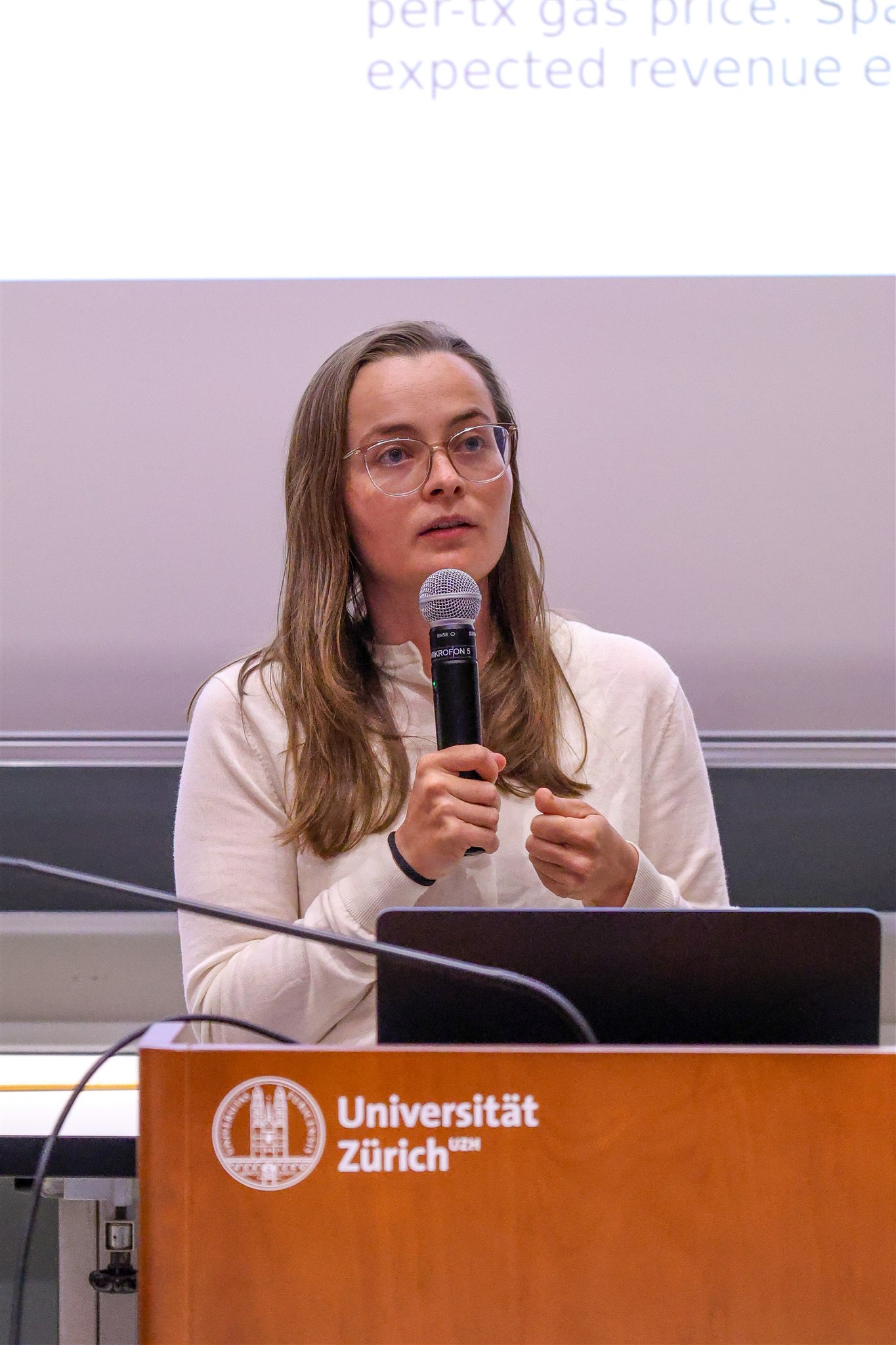 Female speaker presenting at EthereumZüri conference at University of Zurich