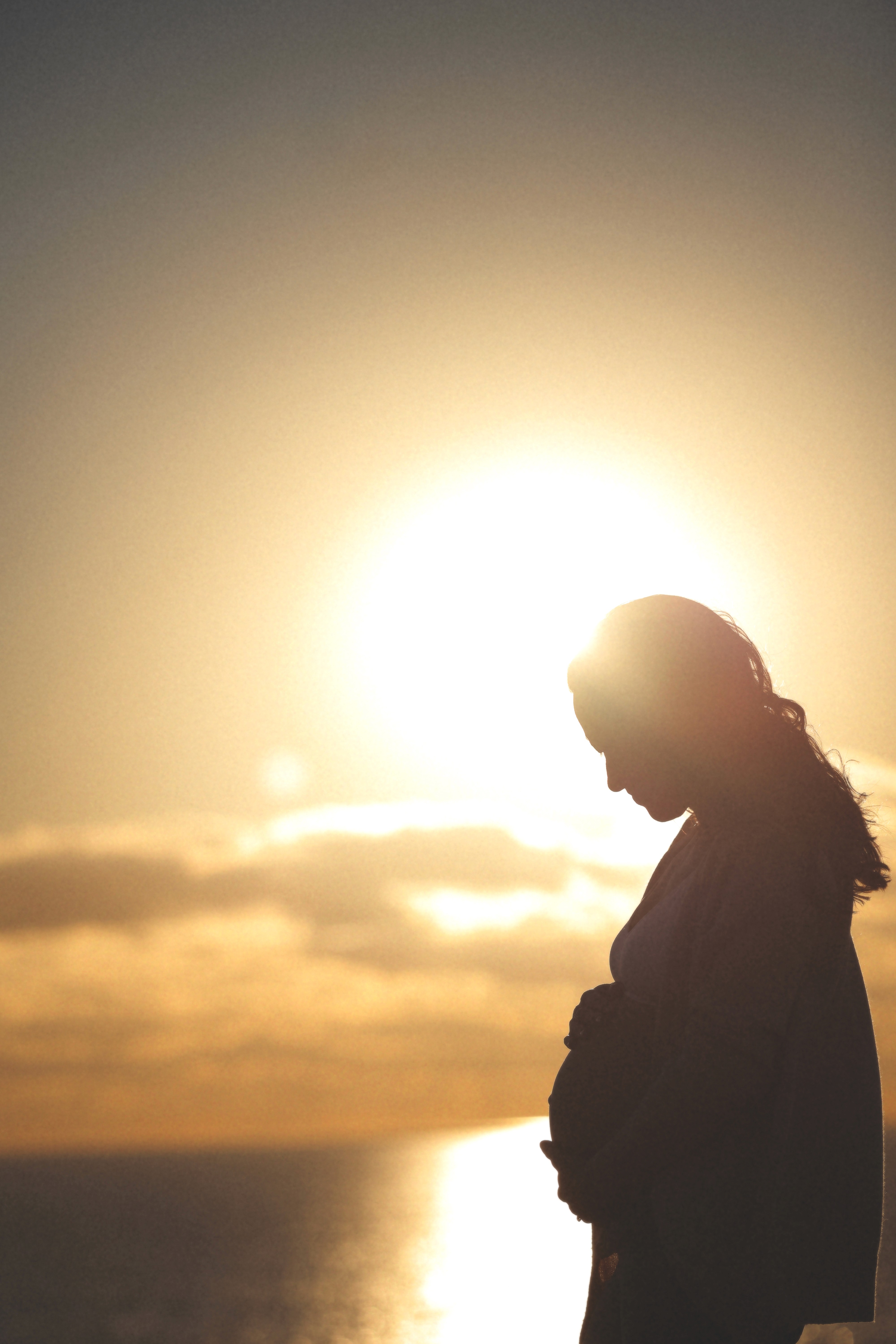 warm sunset light during a maternity session.