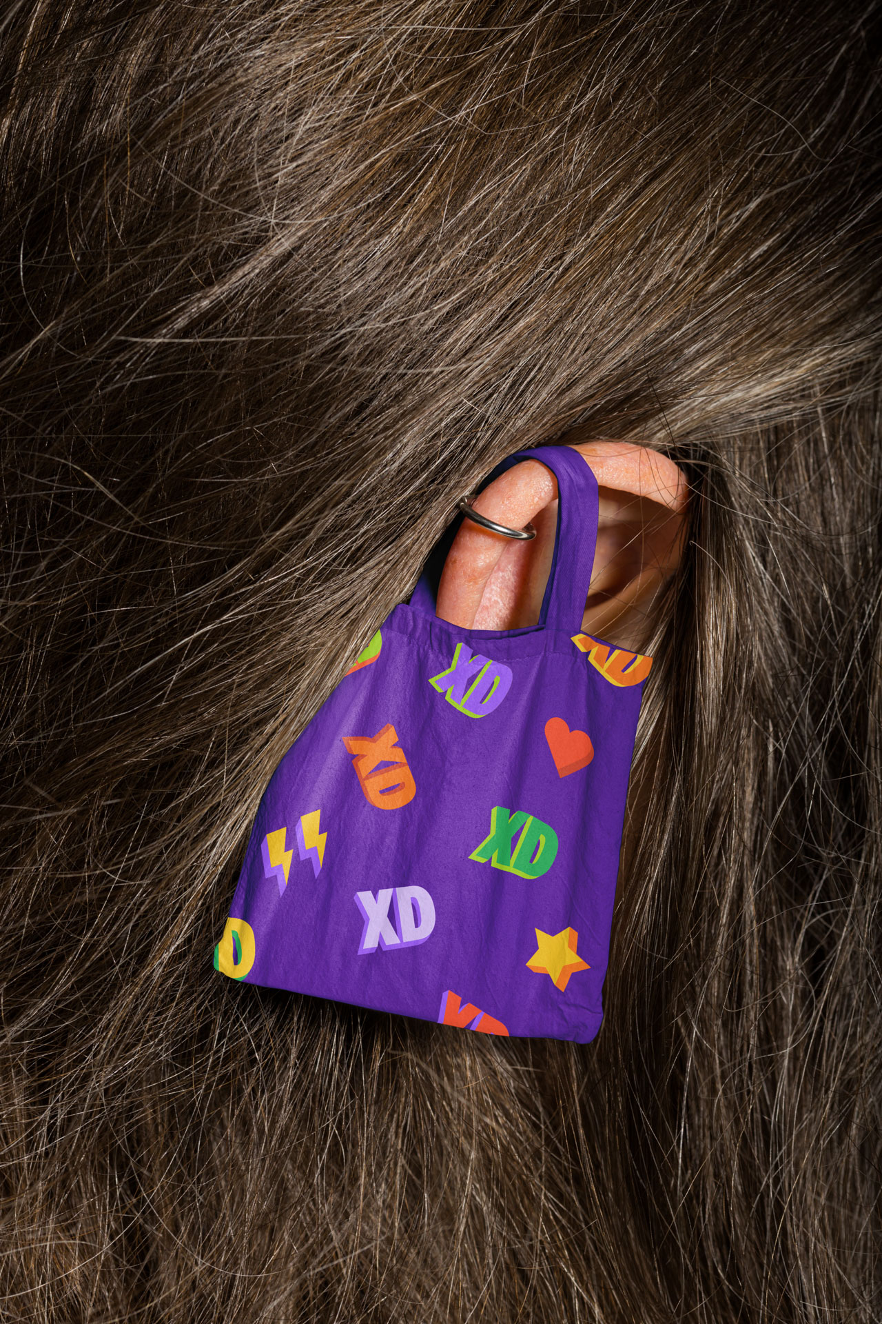 Foxdeli tote bag with the XD emoticon pattern from the brand identity system