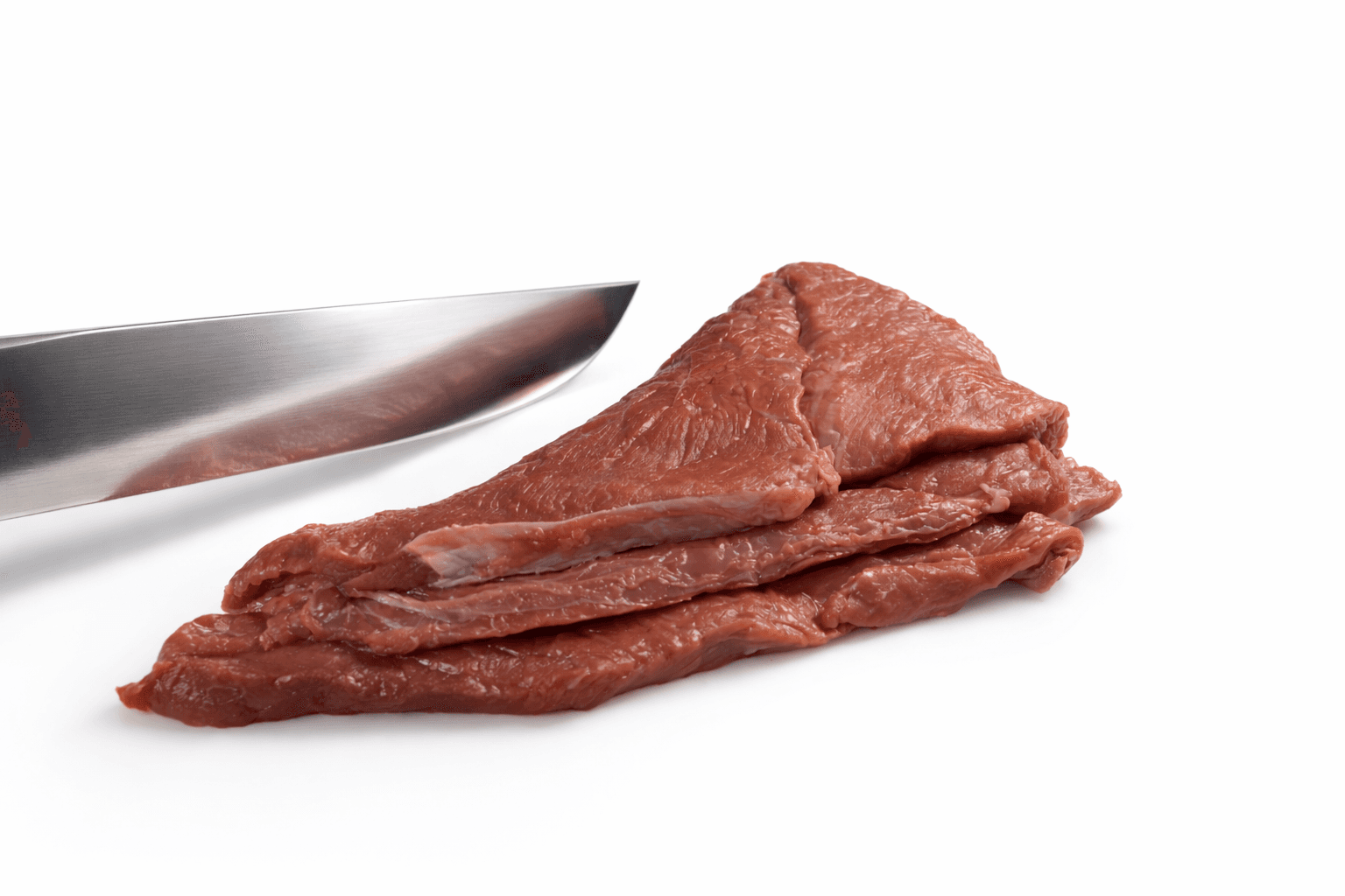 A rustic kitchen scene featuring glass jars of sourdough starter on a wooden table, with a notebook filled with handwritten recipes, a brown bowl of flour, and a beige fabric apron, illuminated by soft natural light from a window.