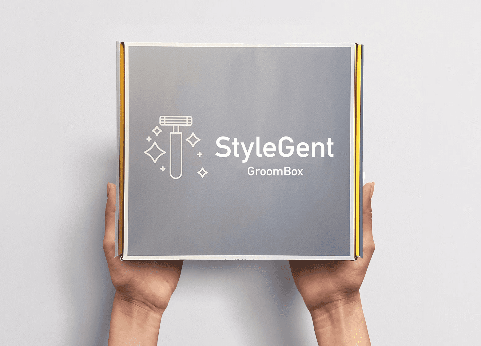 A sleek StyleGent subscription box in a refined grey finish with subtle yellow accents, designed with clean lines and minimalist branding