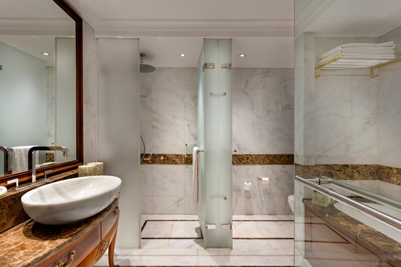 Bathroom with shower or bathtub, makeup mirror, hair dryer, and branded amenities.