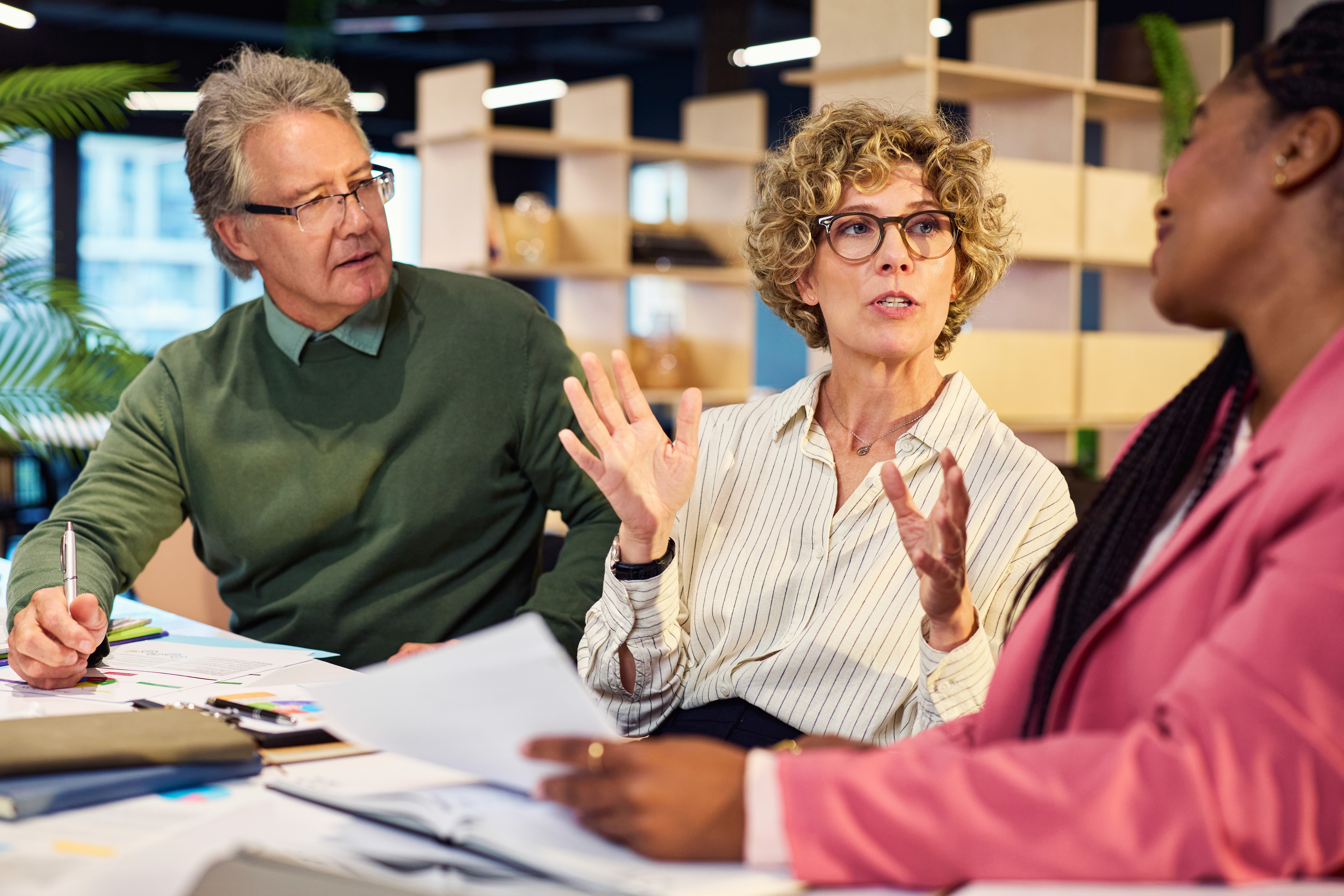 a boy and a girl sitting at a table with a laptop